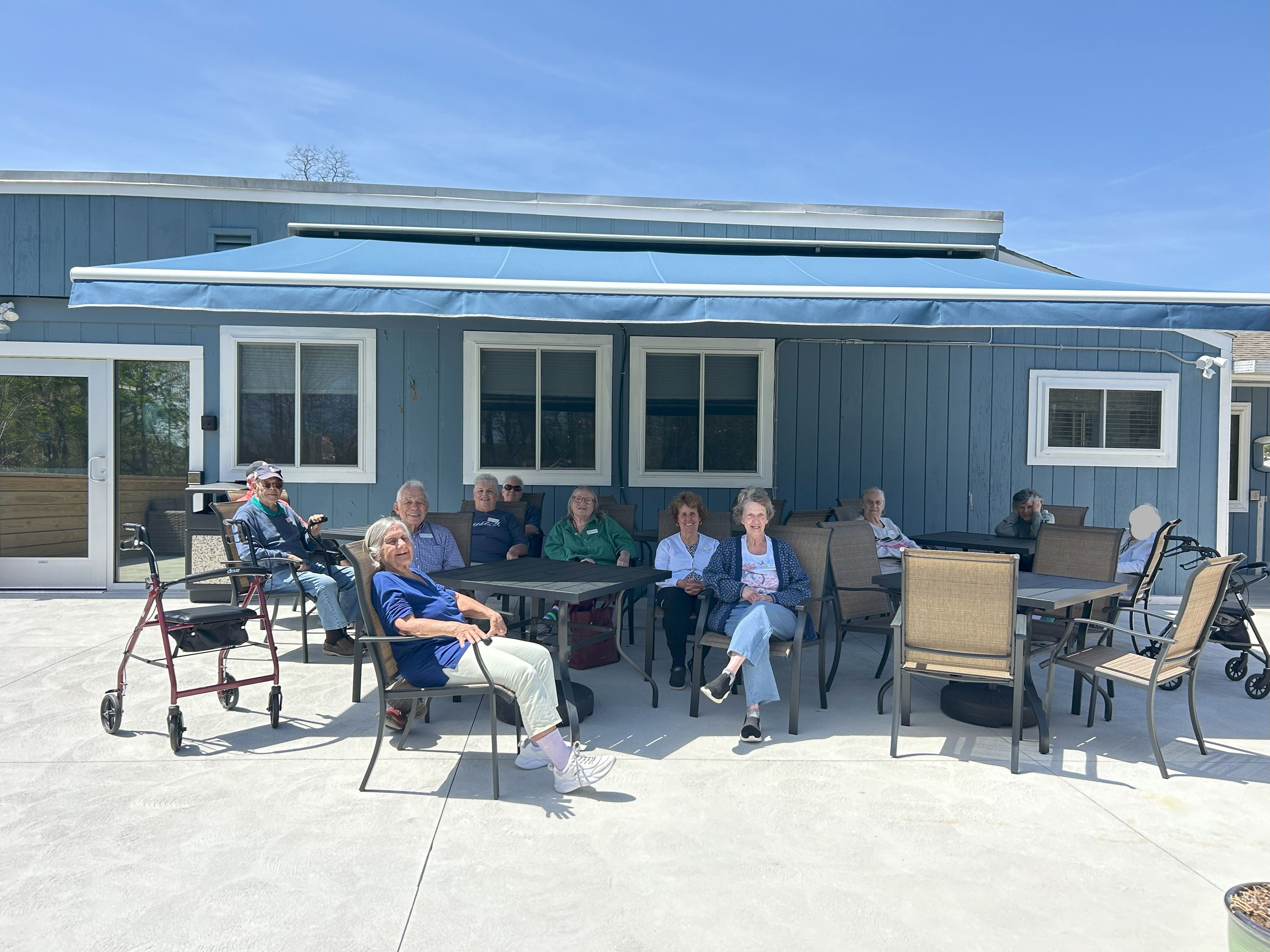 Prime Time attendees enjoying the sun and awning on the Patio.